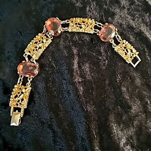 Sarah Coventry Goldtone Bracelet with three purple glass stones. Size 7 in lengt